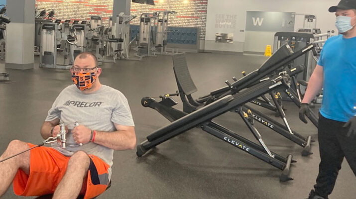 Brandon Anderson, personal trainer with Blink Fitness in Syracuse (right) working with a client, Michael Ostrander. “Working out in the morning creates endorphins that help you feel better all day,” Anderson says.