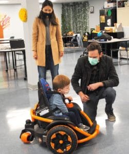 Grant Trout, 3, with his father, Jon, and his mother, Christina, enjoying his redesigned Fisher-Price “Wild Thing” toy.