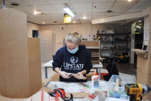 Volunteer Jessica Degina working on designing and building adaptive equipment at ARISE’s adaptive design program in Syracuse.