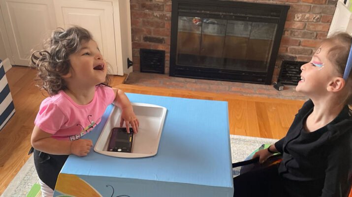 Dylan Malone, left, using her new adaptive stander. On the right is her sister, Chloe.