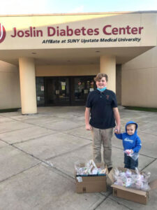 Regan Shetsky’s big brother Gavin and little brother Grayson help in the efforts to distribute Christmas ornaments to adults and children as part of Regan’s Acts of Kindness’ annual event. Jan 4 marks the fourth year of the death of their sister, Regan.