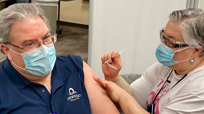 Physician Duane Tull, chief medical officer at Oswego Health, getting his COVID-19 vaccine shot