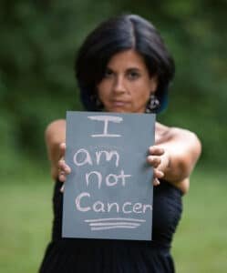 AnnMarie Giannino of Fayetteville holding a sign. Photo courtesy of Genevieve Fridley Photography.