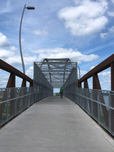 Honeywell paved the West Shore trail leading up to the bridge, which measures 1,000 feet long and 12 feet wide and allows users to safely cross over CSX railroad tracks below. The bridge’s incline complies with the Americans with Disabilities Act